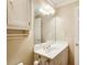 Bathroom with a white vanity, decorative mirror and light fixture, complemented by gold hardware at 2885 Coles Way, Atlanta, GA 30350