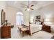 Cozy bedroom with a queen-sized bed, a ceiling fan, and an arched window at 2885 Coles Way, Atlanta, GA 30350