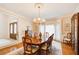 Dining room with hardwood floors, chandelier, large windows, and ornate wood furniture at 2885 Coles Way, Atlanta, GA 30350