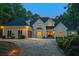 Charming two-story home with a well-manicured lawn, mature trees, and tasteful outdoor lighting, creating curb appeal at 2885 Coles Way, Atlanta, GA 30350