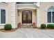 Close-up of the home's double front doors with decorative glass, sidelights and manicured bushes at 2885 Coles Way, Atlanta, GA 30350