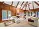 Living area featuring wood paneling, high ceilings, fireplace, and natural light at 2885 Coles Way, Atlanta, GA 30350