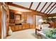 Living room with wood paneled walls, beamed ceilings, and built-in cabinetry at 2885 Coles Way, Atlanta, GA 30350