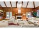 Spacious living room with a fireplace, wood paneling, and comfortable seating at 2885 Coles Way, Atlanta, GA 30350