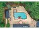 Aerial view of a private pool area with a hot tub, patio, lounge chairs, and manicured landscaping at 2885 Coles Way, Atlanta, GA 30350