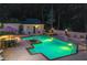 Nighttime pool and spa area with patio seating and lush landscaping, creating a serene and luxurious outdoor retreat at 2885 Coles Way, Atlanta, GA 30350