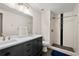 Updated bathroom featuring dual sinks, modern vanity, and a tiled walk-in shower at 374 Lamancha Ct, Lawrenceville, GA 30044