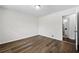 Bedroom featuring wood-look flooring and a glimpse into the adjacent bathroom at 374 Lamancha Ct, Lawrenceville, GA 30044