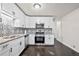 Bright kitchen features white cabinets, stainless steel appliances and tile backsplash at 374 Lamancha Ct, Lawrenceville, GA 30044