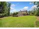 Spacious backyard featuring a well-maintained lawn, wooden deck with stairs, and view of the home's rear exterior at 1344 Hamilton Creek Nw Dr, Kennesaw, GA 30152