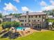 Aerial view of a backyard with a swimming pool, patio area, and mature trees at 1344 Hamilton Creek Nw Dr, Kennesaw, GA 30152