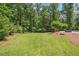 Lush backyard with manicured lawn, offering a serene and private outdoor space bordered by mature trees and landscaping at 1344 Hamilton Creek Nw Dr, Kennesaw, GA 30152