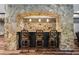 Stylish bar area with stone detailing, elegant stools, and modern lighting, perfect for entertaining guests at 1344 Hamilton Creek Nw Dr, Kennesaw, GA 30152
