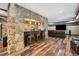 Cozy bar area with stone accents, stools, and dark cabinetry, creating a warm and inviting ambiance at 1344 Hamilton Creek Nw Dr, Kennesaw, GA 30152