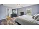 Bedroom with neutral-toned walls, hardwood flooring, a large dresser, and bright natural light at 1344 Hamilton Creek Nw Dr, Kennesaw, GA 30152