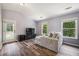 Bedroom area featuring a large chaise lounge chair and natural light through two windows at 1344 Hamilton Creek Nw Dr, Kennesaw, GA 30152