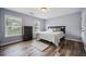 Bedroom featuring hard wood floors, a large window, and a queen-size bed at 1344 Hamilton Creek Nw Dr, Kennesaw, GA 30152