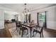 Spacious dining room with hardwood floors, wainscoting, and a view into living area at 1344 Hamilton Creek Nw Dr, Kennesaw, GA 30152