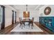 Traditional dining room featuring decorative wainscoting, hardwood floors, and modern chandelier at 1344 Hamilton Creek Nw Dr, Kennesaw, GA 30152