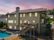 Rear exterior of home with a deck, stairs, and a pool under a colorful twilight sky at 1344 Hamilton Creek Nw Dr, Kennesaw, GA 30152