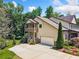 Side view of a two-story home featuring a balcony, garage, and manicured landscaping at 1344 Hamilton Creek Nw Dr, Kennesaw, GA 30152