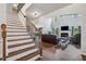 Bright foyer with hardwood floors, staircase, and living room featuring a fireplace and high ceilings at 1344 Hamilton Creek Nw Dr, Kennesaw, GA 30152