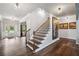 Welcoming foyer with hardwood floors, staircase, and an entry door at 1344 Hamilton Creek Nw Dr, Kennesaw, GA 30152