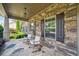 Charming front porch with stone flooring and walls, plus rocking chairs for relaxing outdoors at 1344 Hamilton Creek Nw Dr, Kennesaw, GA 30152