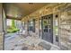 Inviting stone front porch featuring rocking chairs and a decorative wreath on the front door at 1344 Hamilton Creek Nw Dr, Kennesaw, GA 30152