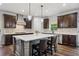 Modern kitchen with gray and dark brown cabinetry, stainless steel appliances, and a central island at 1344 Hamilton Creek Nw Dr, Kennesaw, GA 30152