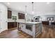 Modern kitchen features a center island with seating, stainless steel appliances and hardwood floors at 1344 Hamilton Creek Nw Dr, Kennesaw, GA 30152