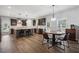 Open-concept kitchen with island seating, stainless steel appliances, and hardwood floors at 1344 Hamilton Creek Nw Dr, Kennesaw, GA 30152