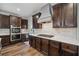Gourmet kitchen featuring stainless steel appliances, granite countertops, and dark wood cabinets at 1344 Hamilton Creek Nw Dr, Kennesaw, GA 30152