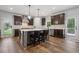 Beautiful kitchen with large island, pendant lighting, stainless steel appliances, and wood floors at 1344 Hamilton Creek Nw Dr, Kennesaw, GA 30152
