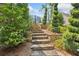Stone steps leading through lush landscaping, enhancing the property's curb appeal at 1344 Hamilton Creek Nw Dr, Kennesaw, GA 30152