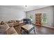 Cozy living room featuring a piano, hardwood floors, and comfortable seating at 1344 Hamilton Creek Nw Dr, Kennesaw, GA 30152
