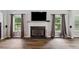 Living room featuring a fireplace, large windows, and hardwood floors at 1344 Hamilton Creek Nw Dr, Kennesaw, GA 30152