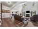 Open living room with hardwood floors, fireplace, high ceilings, and seamlessly connects to the kitchen at 1344 Hamilton Creek Nw Dr, Kennesaw, GA 30152