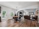 Open living room features hardwood floors, a fireplace, a dining area and lots of natural light at 1344 Hamilton Creek Nw Dr, Kennesaw, GA 30152