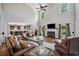 Spacious living room with hardwood floors, fireplace, high ceilings, and seamless kitchen access at 1344 Hamilton Creek Nw Dr, Kennesaw, GA 30152