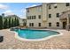 Backyard swimming pool with a waterfall feature and lush landscaping; perfect for outdoor relaxation and entertainment at 1344 Hamilton Creek Nw Dr, Kennesaw, GA 30152