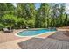 An inviting in-ground pool with lounge chairs and a waterfall feature, surrounded by lush landscaping at 1344 Hamilton Creek Nw Dr, Kennesaw, GA 30152