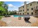 Backyard swimming pool with a stone patio, lounge furniture, and lush landscaping with mature trees at 1344 Hamilton Creek Nw Dr, Kennesaw, GA 30152