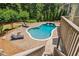 Inviting backyard pool area featuring lounge chairs, a fire pit, and elegant stone paving, perfect for relaxation at 1344 Hamilton Creek Nw Dr, Kennesaw, GA 30152