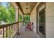 Outdoor porch with two red chairs with wood flooring and railings at 1344 Hamilton Creek Nw Dr, Kennesaw, GA 30152
