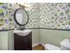 Charming powder room featuring lemon-themed wallpaper, a modern sink, and decorative accents at 1452 Crooked Tree Cir, Stone Mountain, GA 30088