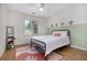 Bright bedroom featuring stylish decor, a ceiling fan, and a view of the outdoors at 1452 Crooked Tree Cir, Stone Mountain, GA 30088