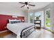 Cozy bedroom with a color block wall and abundant natural light from the bay windows at 1452 Crooked Tree Cir, Stone Mountain, GA 30088
