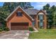 Charming two-story brick home with a well-manicured lawn and a quaint blue front door at 1452 Crooked Tree Cir, Stone Mountain, GA 30088