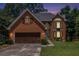 Brick home with attached garage, bay window and traditional-style front door at 1452 Crooked Tree Cir, Stone Mountain, GA 30088